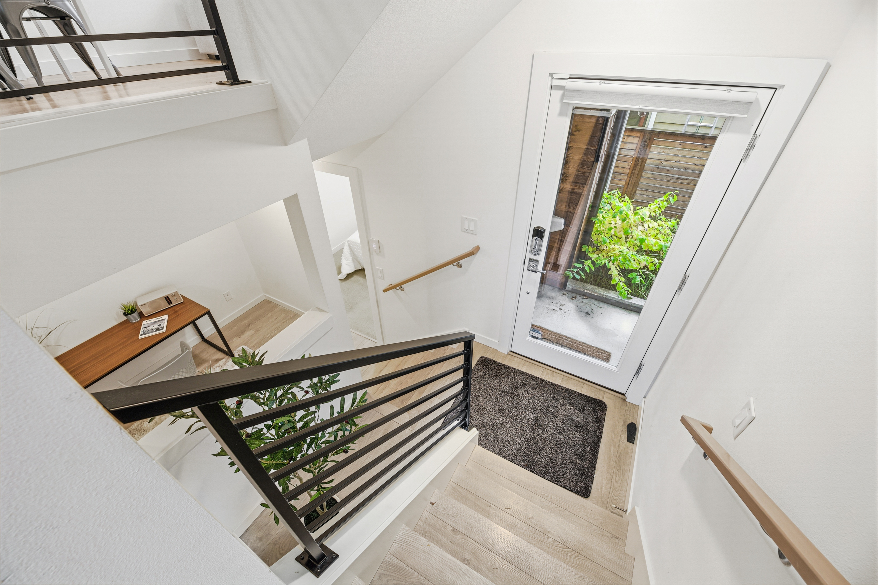 View from upper level showing entry door and open-concept layout