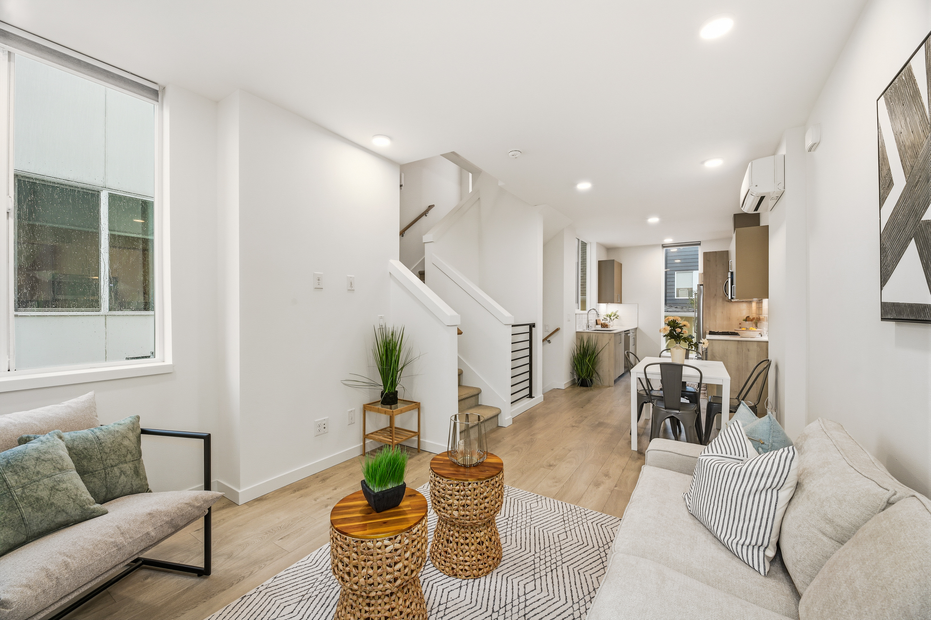 Open concept living room with dining area and stairs